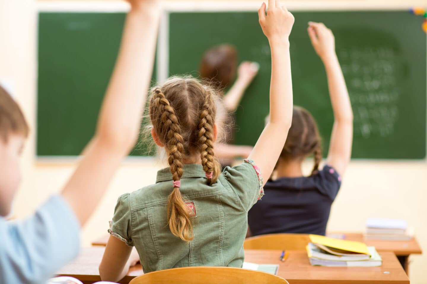 students raising their hands