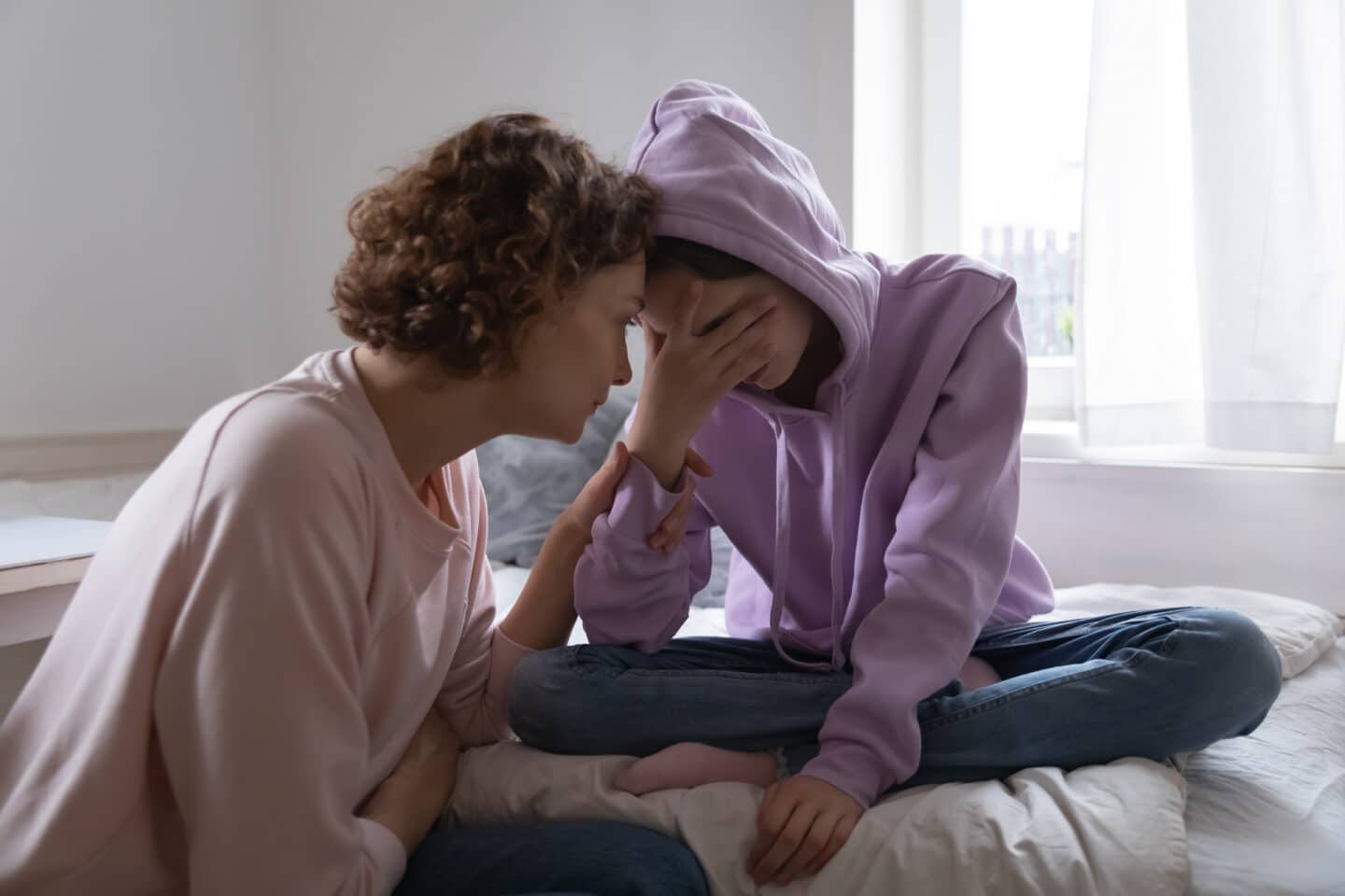 mother helping daughter who is sad