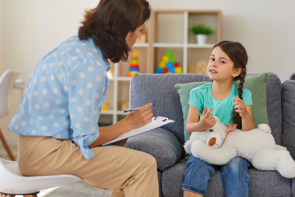 therapist helping young girl