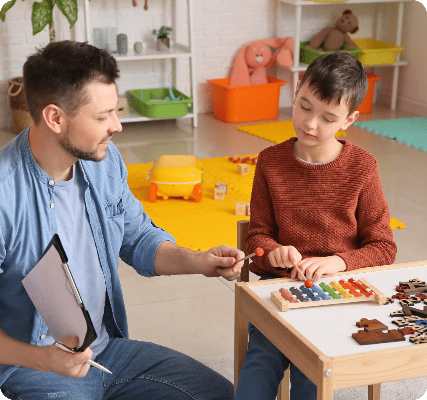 male therapist helping boy