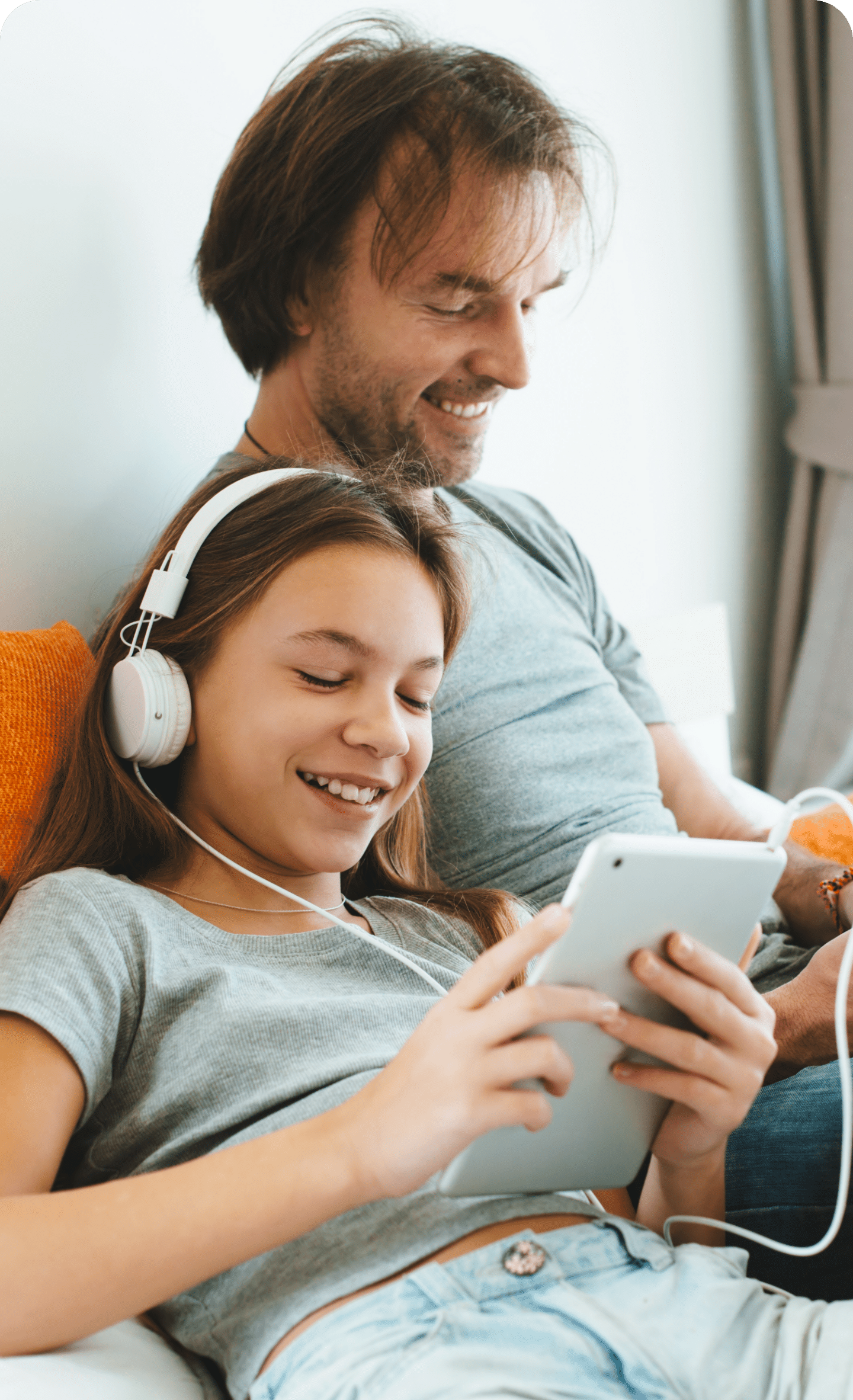 teen on phone with headphones with her dad