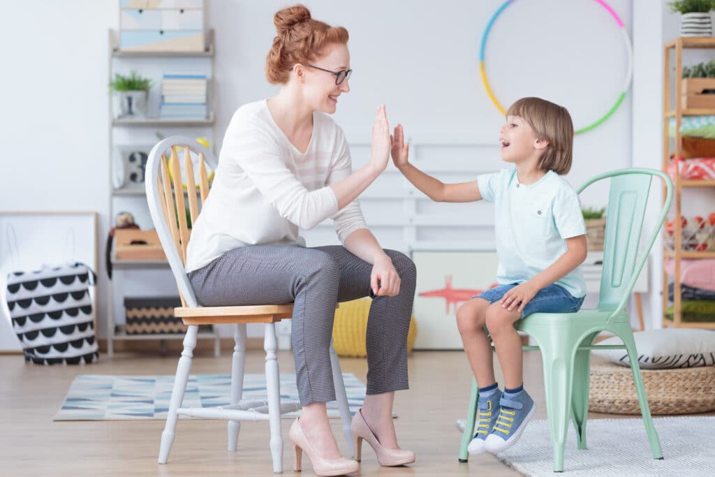 woman high five young boy